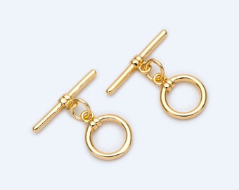 May include: Two gold-colored toggle clasps. Each clasp features a T-bar and a circular ring, connected by a small loop. The clasps are designed for jewelry making and are set against a white background.