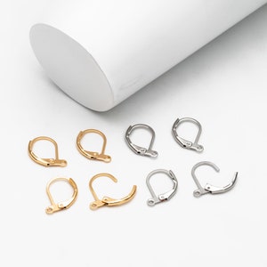 May include: A set of eight earring hooks, four gold and four silver, for jewellery making.