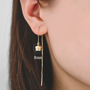 May include: Gold flower dangle earrings with a thin chain. The flower is 8mm in diameter.