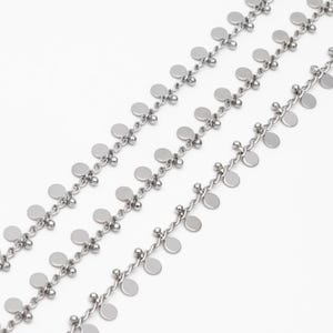 May include: A silver chain necklace with multiple strands of small round discs hanging from it.