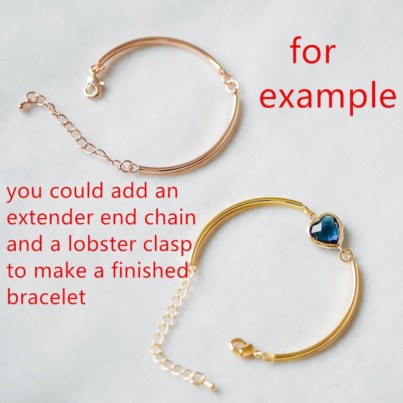 May include: Two gold bracelets, one with a blue heart charm and the other with a chain extender. The text "for example" is written in red above the bracelets.