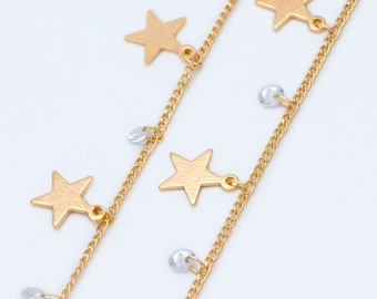 May include: A gold chain necklace with star charms and clear crystal beads.