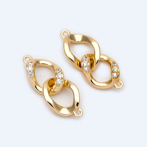 May include: Two gold-tone chain link connectors with clear cubic zirconia stones. Each connector has a loop on either end.