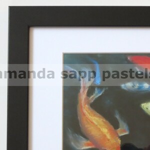 May include: A framed pastel drawing of colorful koi fish swimming in a dark pond. The fish are orange, red, blue, and white. The frame is black with a white mat.
