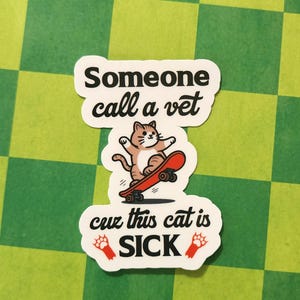 May include: White sticker with black text that says "Someone call a vet cuz this cat is SICK". A cartoon cat is skateboarding with red paw prints on either side of the text.