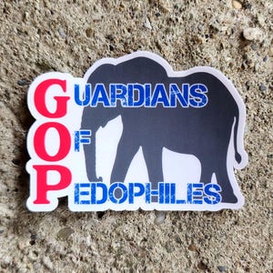 May include: A sticker with the text "GOP" in red, stacked vertically, and "GUARDIANS OF PEDOPHILES" in blue, with a silhouette of an elephant in the center. The sticker is white with a black outline.