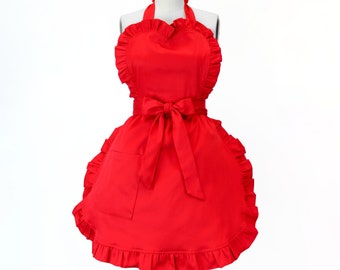 May include: A red heart-shaped apron with a ruffled trim and a single pocket. The apron has a bow tie at the waist.