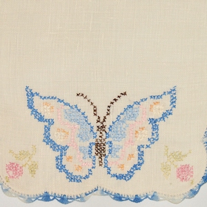 Vintage Cross-Stitch Doily with Blue Butterfly and Pink Flowers