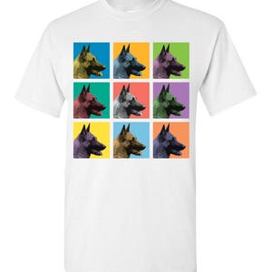 May include: A white t-shirt with a colorful pop art design of nine Belgian Malinois dogs. Each dog is shown in profile with its head turned to the side. The dogs are arranged in a 3x3 grid, with each dog in a different colored square. The colors of the squares are yellow, blue, green, red, orange, purple, pink, brown, and light blue.
