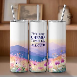 May include: Three stainless steel tumblers with a mountain and flower design. The middle tumbler has the text "This is my CHEMO TUMBLER and I will Destroy it When this is ALL OVER".