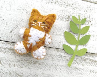 Tiny felt stuffed orange ginger tabby cat with white socks and belly, pocket pet