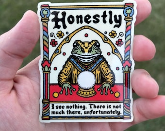 May include: A sticker featuring a cartoon frog wearing a robe and holding a crystal ball. The frog is in a colorful, medieval-style frame with the word "Honestly" at the top. The text below the frog reads "I see nothing. There is not much there, unfortunately."