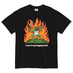 May include: Black t-shirt with a green frog holding a sword in a fiery orange and yellow background. The text "I am at my frogging limit" is printed below the image.