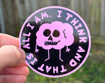 May include: A black and pink round sticker with a cartoon brain with a skull face and the text "IS THAT ALL I AM. I THINK AND"
