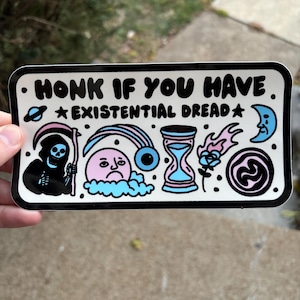 May include: A white sticker with black outlines and colorful illustrations. The sticker says "Honk if you have *Existential Dread*" and features a grim reaper, a sad face in a cloud, an eye, an hourglass, a flame, and a swirl.