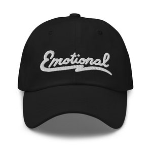 May include: A black baseball cap with a white embroidered cursive word "Emotional" on the front.