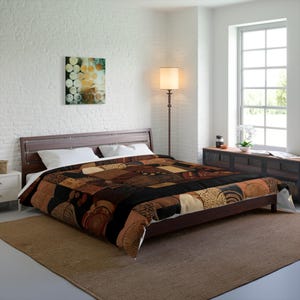 May include: A brown and black comforter with a patchwork design featuring geometric and abstract patterns. The comforter is on a wooden bed frame in a bedroom setting. The room has white walls and a large window.