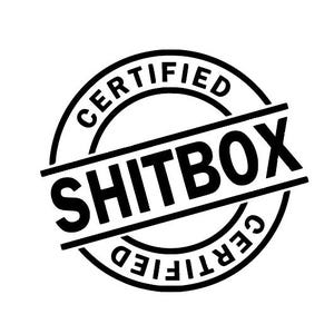 May include: A black and white graphic of a circular stamp that reads "CERTIFIED" around the outer edge. The words "SHITBOX" are printed in bold, black letters across the center of the stamp.