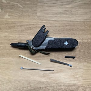 91mm SAK scales with Leatherman bit storage and driver