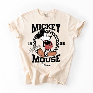 a mickey mouse t - shirt on a white background