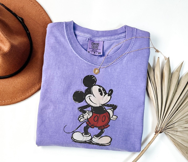 a purple shirt with a mickey mouse on it