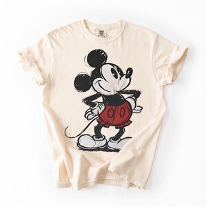 a white shirt with a mickey mouse on it