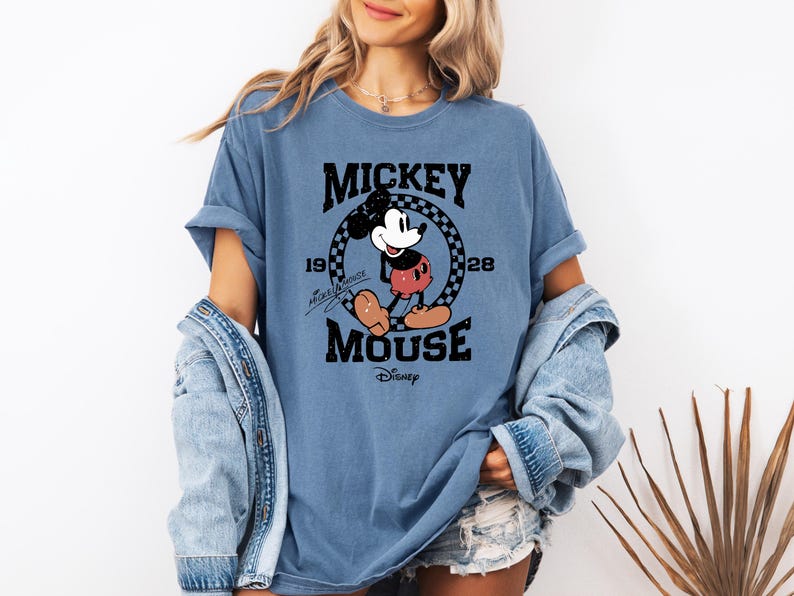 a woman wearing a mickey mouse t - shirt