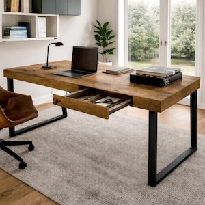 May include: A wooden desk with a black metal frame and an open drawer. A laptop, books, and a desk lamp are on the desk. A brown leather chair sits to the left of the desk. A gray rug covers the floor.