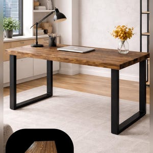 May include: A rectangular desk featuring a dark brown wood grain tabletop with a visible natural knot pattern, supported by two sturdy black metal U-shaped legs. The surface is smooth and finished with a rich, warm-toned wood stain.