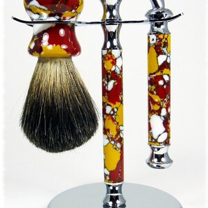 May include: A chrome shaving set with a red, yellow, and white marbled design. The set includes a razor, brush, and stand.