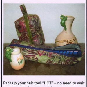 May include: An image of a Curling Coffin & Bitty Box. The Curling Coffin is a heat-resistant fabric case with a floral pattern. A flat iron is inside the case. The image also shows a small vase with a frog figurine.