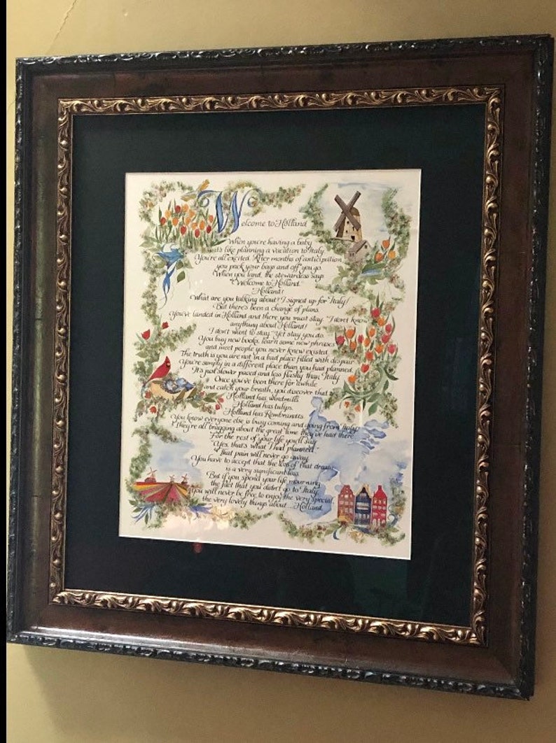 May include: A framed calligraphic poem titled "Welcome to Holland" with a watercolor illustration of a windmill, tulips, and birds. The poem discusses the unexpected journey of parenthood and the beauty of embracing the unexpected.