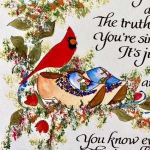 May include: A red cardinal bird perched on top of two wooden clogs with floral designs. The background is a white surface with a handwritten message that reads "You know every one of them is a part of you. The truth is you're simply a part of them. It's just a matter of time. You know every one of them is a part of you. They're all a part of you."