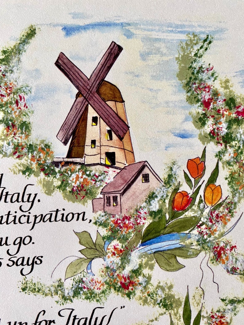 May include: A watercolor painting of a windmill and a small house with a red roof. The windmill has a brown wooden frame and a white sail. The house has a brown wooden frame and a white door. The painting is surrounded by a border of green leaves and red flowers.
