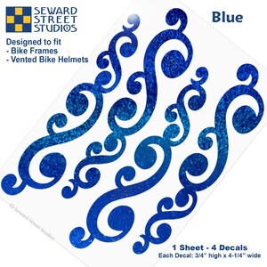 May include: A sheet of four blue glittery scrollwork decals designed for bike frames and vented bike helmets. The text reads Seward Street Studios, Blue, Designed to fit Bike Frames, Vented Bike Helmets, and 1 Sheet - 4 Decals, Each Decal: 3/4" high x 4-1/4" wide.