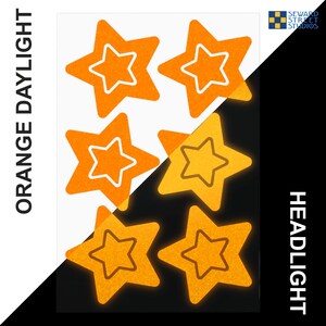 May include: Six orange glow-in-the-dark star stickers. The stars are shown in two rows of three. The top row shows the stars in daylight, and the bottom row shows the stars in the dark. The text "ORANGE DAYLIGHT" is on the left side of the image, and the text "HEADLIGHT" is on the right side of the image.