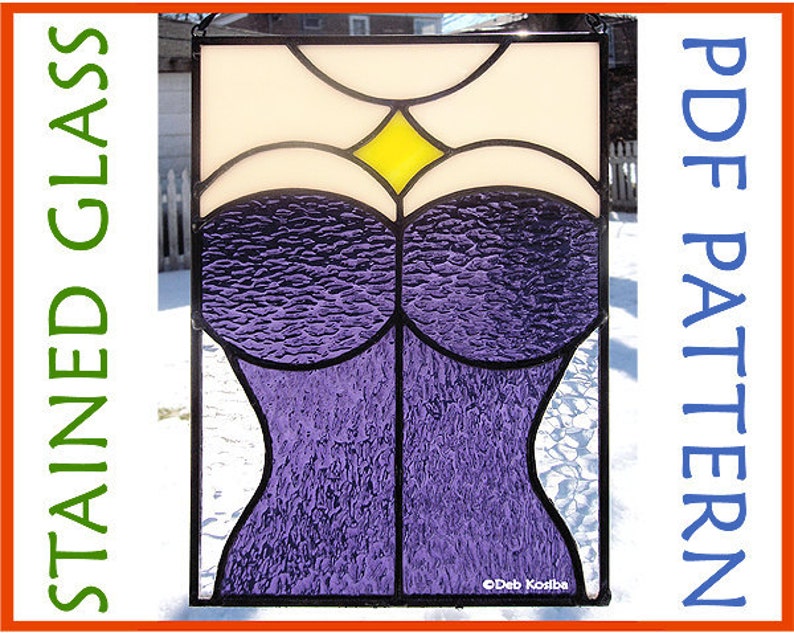 May include: A stained glass window design featuring a purple corset with a yellow diamond in the center. The design is framed in black and set against a snowy background.