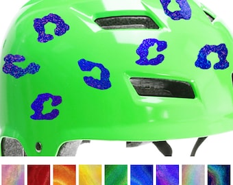 May include: A bright green helmet with blue glitter leopard print decals. The image shows a variety of holographic glitter colors. The text at the bottom reads "9 Holographic Glitter Colors!"