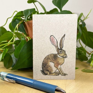 Mini notebook with jackrabbit on cover, pocket in back, and 48 lightly gridded pages. All recycled. Hand sewn with linen thread. image 1