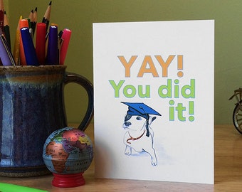 Graduation card with cute dog saying, Yay! You did it! Inside - Congratulations! (Not that we're surprised). Choice of colors.