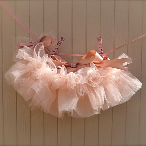 Baby Ballerina Antique Pink Newborn Tutu. Teeny, tiny and can be hung in the nursery. Clothes pins and ribbon included.