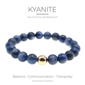 May include: A blue kyanite gemstone bracelet with a 14k gold filled bead. The bracelet is made in Canada and is described as promoting balance, communication, and tranquility.
