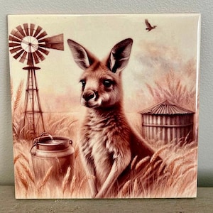 May include: A brown kangaroo with a windmill and a water bucket in the background. The kangaroo is sitting in a field of tall grass.