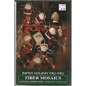 May include: A craft pattern booklet titled 88701 Holiday Fru-Fru Fiber Mosaics featuring various fabric Santa Claus ornaments, stockings, and holiday-themed decorations in shades of red, cream, and brown with visible stitching details.