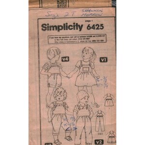 May include: A vintage Simplicity 6425 sewing pattern for children's clothing. The pattern features illustrations of children in various outfits, including overalls and a dress. The size is 2T. The text includes contact information.
