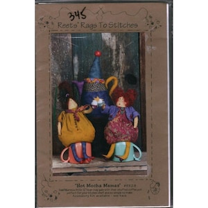 May include: A craft kit titled "Hot Mocha Mamas" featuring two whimsical dolls seated on mugs, with a decorative teapot in the background. The dolls have colorful clothing and wild hair. The kit includes instructions and materials for creating the dolls.