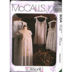 May include: A McCall's 8004 sewing pattern envelope featuring illustrations of three different nightgowns with lace detailing. The text includes the brand name McCall's, the pattern number 8004, size Ex-Large, and the Alicyn Exclusives logo.