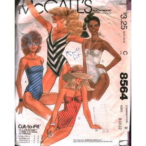 May include: Vintage McCall's sewing pattern featuring illustrations of women in swimwear. The pattern includes various swimsuit designs, including striped and solid color options. The pattern number is 8564, with sizes 8-10-12.