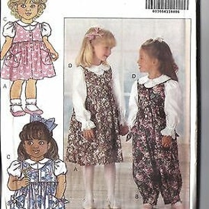 May include: A sewing pattern for children's clothing. The pattern includes three different styles: a pink dress with a white collar, a floral print dress with a white collar, and a floral print jumpsuit with a white collar. The pattern is for sizes 1-3.