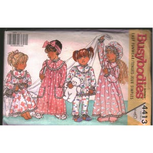 May include: A Butterick Busybodies 4413 sewing pattern envelope featuring illustrations of children in various sleepwear styles, including nightgowns and pajamas with floral and sheep prints, with the text Busybodies and 4413 visible on the side.